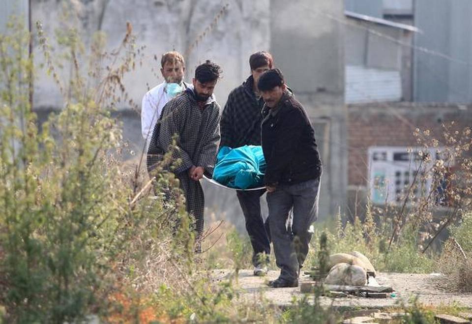 People carry the body of a labourer, who was killed on Tuesdaysouth Kashmir's Kulgam district on October 30, 2019